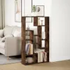 A bookshelf filled with books and decorative items in a living room setting next to a sofa. Náhled obrázku produktu