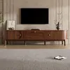 A modern living room scene featuring a wooden TV stand with a television mounted above it, and a rug in the foreground. Podgląd zdjęcia produktu
