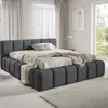 A modern bedroom with a large upholstered bed. Produktbild-Vorschau