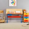 A child's desk setup in a room with a grey wall and a fluffy carpet. Produktbild-Vorschau