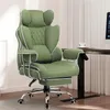 A green office chair with a footrest is shown in a room with a desk and curtains. Produktbild-Vorschau