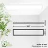 A diagram showing the dimensions of a rectangular LED ceiling light, with a partial view of the light fixture on a ceiling and a plant in the foreground. Produktbild-Vorschau