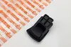 A black plastic part, likely a component for a power tool, is placed on a white surface next to a piece of clear plastic packaging with orange branding. Produktbild-Vorschau