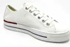 A white leather sneaker with red and blue accents on the sole, shown against a white background. Produktbild-Vorschau