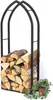 A black metal firewood rack filled with logs, with a small potted plant and ivy to the side. Podgląd zdjęcia produktu
