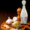 A kitchen scene with garlic, spices, and a food chopper. Náhľad obrázku produktu