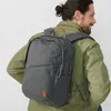 A man wearing a green jacket is carrying a gray backpack. Náhled obrázku produktu