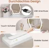 A vanity mirror with LED lighting and a USB connection, shown on a white vanity table with makeup brushes and other accessories. Produktbild-Vorschau