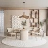 A dining room setting with a round table and chairs. Produktbild-Vorschau