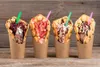 Four bubble waffle ice cream cones arranged on a wooden surface. Podgląd zdjęcia produktu