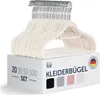 A stack of ivory-colored velvet hangers on top of a product box. Náhled obrázku produktu