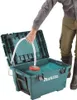 A person is using a portable pressure washer in a teal case filled with water. Náhled obrázku produktu