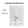 The back of a white makeup mirror with a stand, showing a USB connection port and a label with product information. Text overlays indicate features. Produktbild-Vorschau