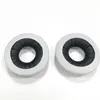 Two white headphone ear pads with black inner padding are shown against a white background. Náhled obrázku produktu