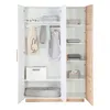 An open three-door wardrobe with shelves and hanging space, displaying folded clothes, a tote bag, a sleeping bag, and a pet bed. Produktbild-Vorschau