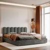 A modern bedroom scene featuring a gray upholstered bed. Anteprima dell’immagine prodotto