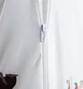 A close-up of a white zipper on a white fabric. Podgląd zdjęcia produktu