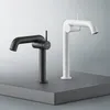 Two modern faucets, one black and one white, are displayed on a gray platform against a gradient background. Produktbild-Vorschau