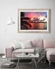 A living room scene with a pink sofa, coffee table, and a framed picture on the wall. Produktbild-Vorschau