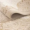A close-up view of a rolled-up rug, showing its texture and pattern. Voir les images du produit