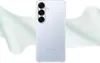The back of a transparent phone case is shown against a white and light green background with abstract wavy shapes. Produktbild-Vorschau