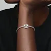 A close-up shot of a person's arm wearing a silver bracelet with an elephant charm. Podgląd zdjęcia produktu