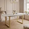 A dining room with a marble-top table and gold legs, set with a vase of flowers. Produktbild-Vorschau