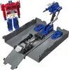 A toy robot and its accessories are displayed on a gray base. Produktbild-Vorschau