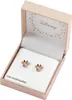 A pair of Minnie Mouse-shaped earrings with clear stones and a rose gold finish, presented in an open pink box with a Disney logo and star pattern inside. Produktbild-Vorschau