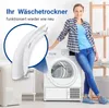 A woman is standing next to a washing machine, with a close-up of a white dryer door handle in the foreground. The scene appears to be a laundry room. Produktbild-Vorschau