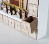 A close-up view of a wooden advent calendar with small drawers and figures, set against a neutral background. Anteprima dell’immagine prodotto
