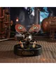 A steampunk-style mechanical rhinoceros beetle model on a black circular base, set against a background of industrial pipes and machinery. Náhľad obrázku produktu