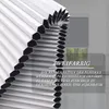 A close-up of a white pleated blind with black honeycomb structures, with text overlay describing its features. Produktbild-Vorschau