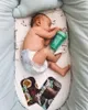 A baby sleeping in a crib with a baby bottle and two pacifiers. Podgląd zdjęcia produktu