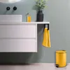 A modern bathroom vanity with a white sink, white drawers, and yellow accessories including a trash can and towels. Anteprima dell’immagine prodotto