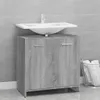 A bathroom vanity with a sink and faucet against a tiled wall. Produktbild-Vorschau