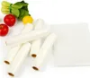 Several rolls of vacuum sealer bags are arranged on a white surface, with some fresh produce (apples, lemon, bok choy) in the background. Produktbild-Vorschau