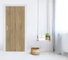 A wooden door with a white frame, a decorative swing with a plant and a "GOOD MORNING" sign, and a woven basket on a white floor. Produktbild-Vorschau