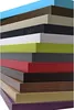 A stack of colorful boards, likely for furniture or interior design. Náhled obrázku produktu