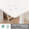 A close-up of a white C-shaped table with water droplets on its surface, showing its waterproof feature. The table leg is visible, and a shelf with bottles is underneath. Logos and text describing features are present at the bottom. Produktbild-Vorschau