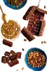 A collection of chocolate bars, chocolate spread, and pistachios, arranged in a visually appealing manner. Podgląd zdjęcia produktu