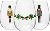 Three clear stemless wine glasses with Christmas-themed nutcracker and holly designs. Produktbild-Vorschau