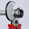 A close-up view of a pipe cutter gripping a pipe. Produktbild-Vorschau