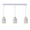 A three-light pendant lamp with white and gold cylindrical shades, suspended from a white bar. Náhľad obrázku produktu