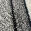 A close-up view of a textured carpet with a dark stripe running through it and a zipper on the right side. Anteprima dell’immagine prodotto