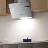 A modern kitchen scene with a stainless steel range hood over a countertop. Náhled obrázku produktu