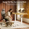 A woman is playing with her cat next to a standing desk in a home office setting. Produktbild-Vorschau