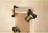 Close-up of corner clamps holding together pieces of wood. Produktbild-Vorschau