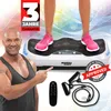 A man pointing at a white vibration plate with a person's legs on it, along with accessories. Podgląd zdjęcia produktu