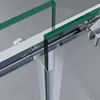 A close-up view of a shower door mechanism, showing the sliding track and glass panels. Produktbild-Vorschau